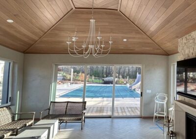 Interior of living room with wood angled vaulted ceiling with fireplace